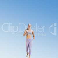 Composite image of sporty blonde jogging towards camera