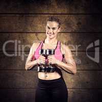 Composite image of muscular woman lifting heavy dumbbells