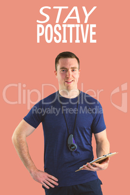 Composite image of attentive trainer writing on his clipboard
