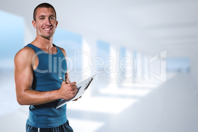 Composite image of portrait of confident sports coach writing on