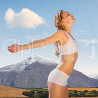 Composite image of gorgeous fit blonde standing with arms out