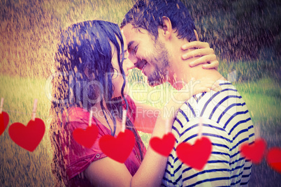 Composite image of cute couple hugging under the rain