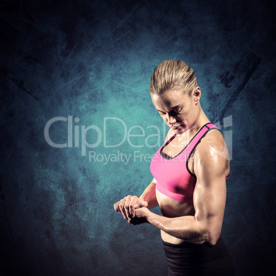 Composite image of muscular woman flexing her arm