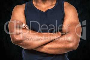 Composite image of fit man with arms crossed