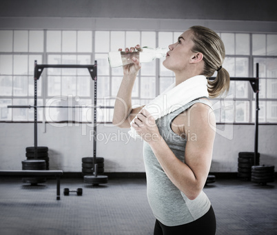 Composite image of fit woman drinking water