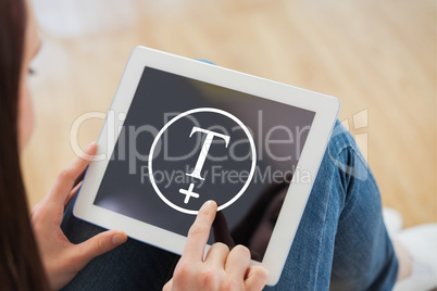 Composite image of teen using a tablet pc sitting on the floor