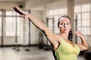 Composite image of beautiful confident athlete stretching hands