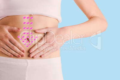 Composite image of slim woman touching her belly