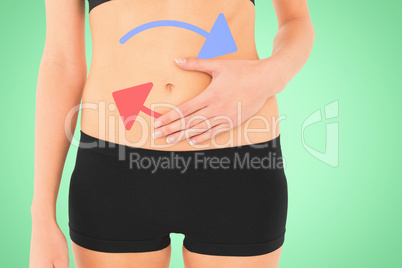 Composite image of closeup mid section of a fit woman with stoma