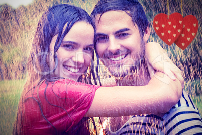 Composite image of cute couple hugging under the rain