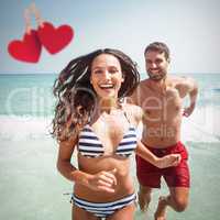 Composite image of happy couple running out water
