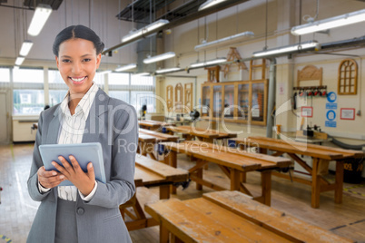 Composite image of businesswoman using a tablet with colleagues