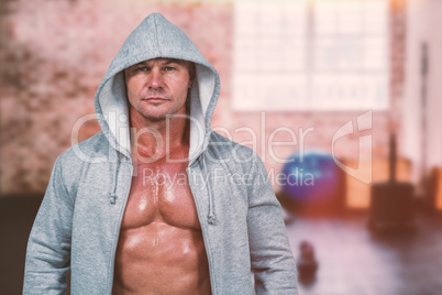 Composite image of portrait of macho man in hood