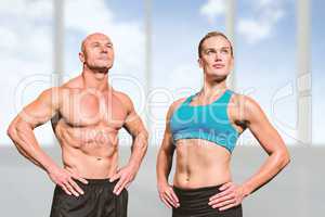 Composite image of muscular man and woman with hand on hip