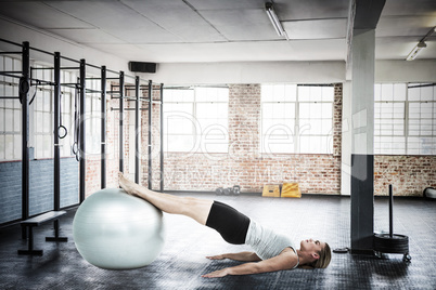 Composite image of  muscular woman lying on floor with legs