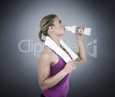 Composite image of muscular woman drinking water