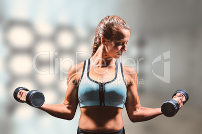 Composite image of sporty woman lifting dumbbells