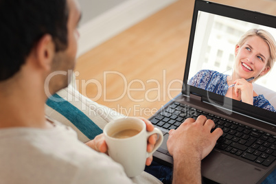 Composite image of man using laptop