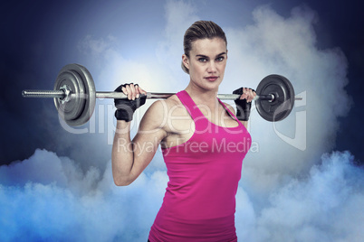 Composite image of fit woman with barbell