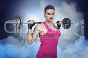 Composite image of fit woman with barbell