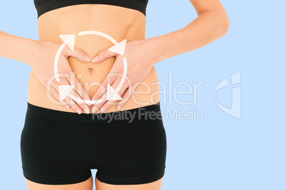 Composite image of closeup mid section of a fit woman in black s