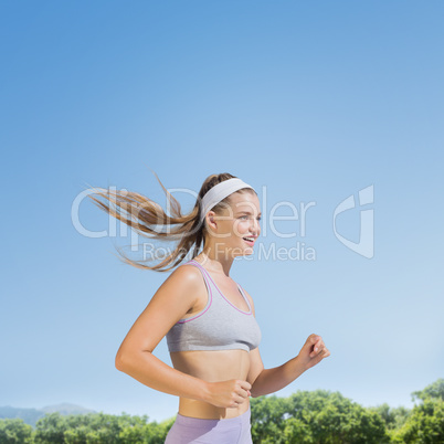 Composite image of sporty smiling blonde jogging