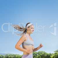 Composite image of sporty smiling blonde jogging