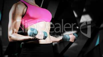 Composite image of muscular woman lifting heavy dumbbells