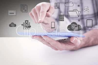 Composite image of casual man using tablet pc