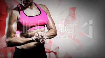 Composite image of muscular woman flexing her arm