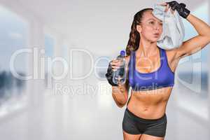 Composite image of exhausted woman wiping sweat while holding wa