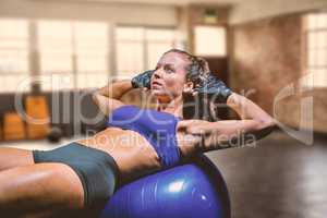 Composite image of woman exercising on ball