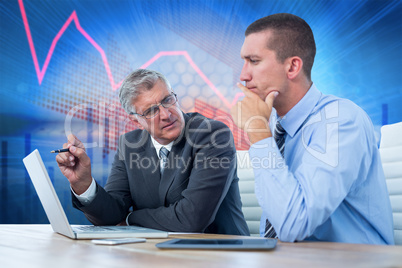 Composite image of businessmen working together with laptop and