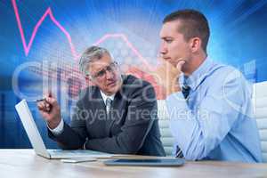 Composite image of businessmen working together with laptop and