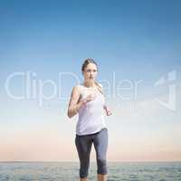 Composite image of focused fit blonde jogging