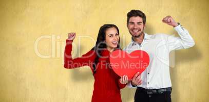Composite image of cheerful couple holding paper heart