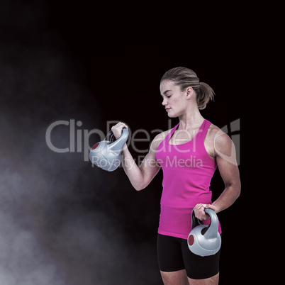 Composite image of muscular woman exercising with kettlebells