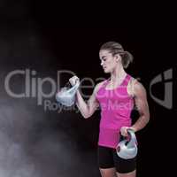 Composite image of muscular woman exercising with kettlebells