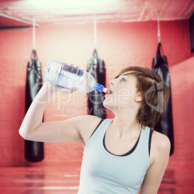 Composite image of pretty brunette drinking water