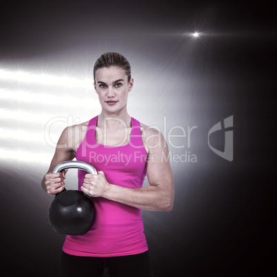 Composite image of muscular woman exercising with kettlebell