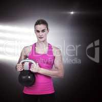 Composite image of muscular woman exercising with kettlebell