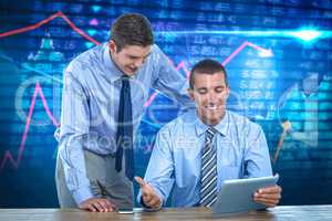 Composite image of businessmen using tablet