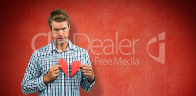 Composite image of sad man with broken heart