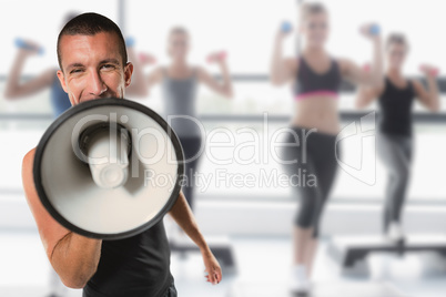 Composite image of male trainer yelling through megaphone