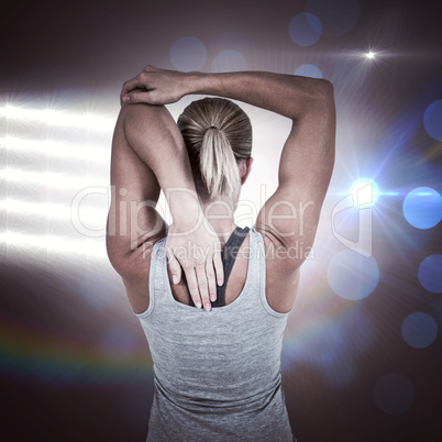 Composite image of rear view of muscular woman stretching her ar
