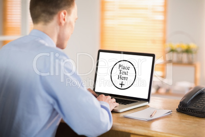 Composite image of businessman working on his laptop