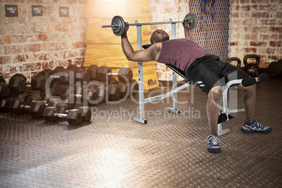 Composite image of fit man exercising with barbell