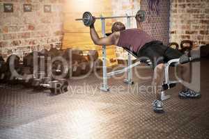 Composite image of fit man exercising with barbell
