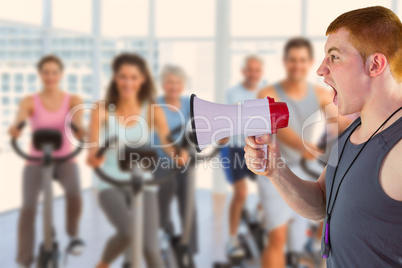 Composite image of angry personal trainer yelling through megaph