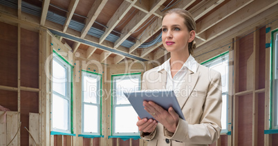 Composite image of pensive stylish businesswoman holding tablet